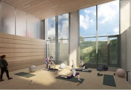 Groep mensen doet aan yoga in een lichte, moderne ruimte aan de Marten Meesweg met hoge ramen.